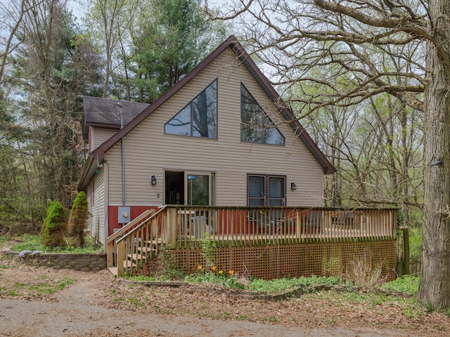 back of house with a deck