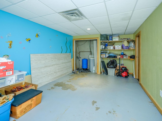 below grade area with a drop ceiling and visible vents