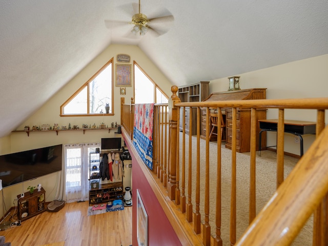 additional living space with ceiling fan, vaulted ceiling, and wood finished floors