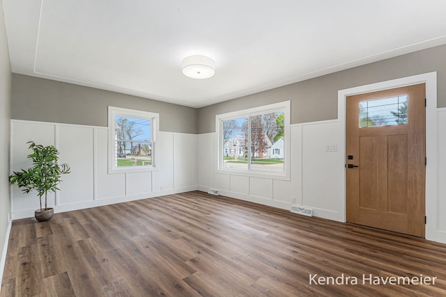 entrance foyer with a healthy amount of sunlight, wood finished floors, and visible vents