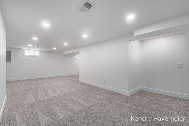 below grade area featuring carpet flooring, recessed lighting, and visible vents