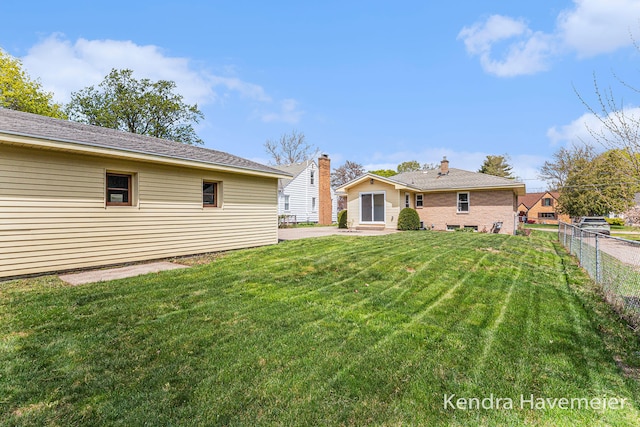 view of yard with fence, a patio, and entry steps