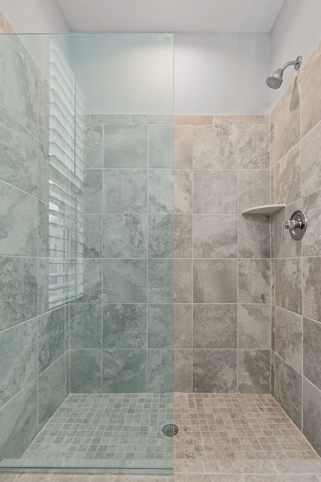 bathroom with tiled shower