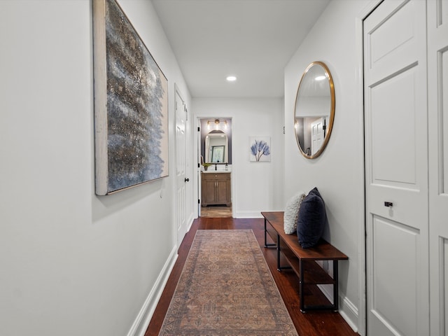 hall featuring recessed lighting, baseboards, and dark wood-style floors