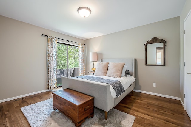 bedroom featuring baseboards, visible vents, and wood finished floors