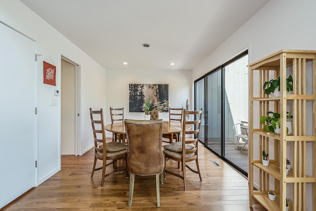 dining space featuring recessed lighting, wood finished floors, and visible vents