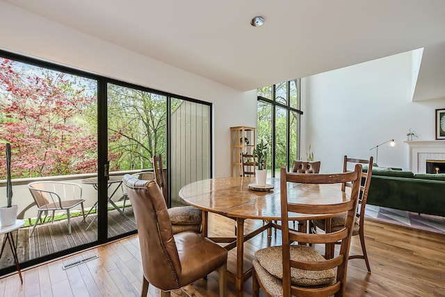 dining room featuring a fireplace and light wood finished floors