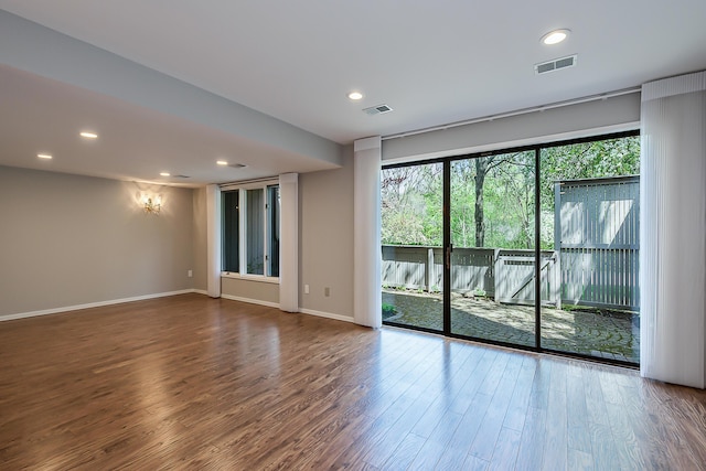 unfurnished room with visible vents, recessed lighting, baseboards, and wood finished floors