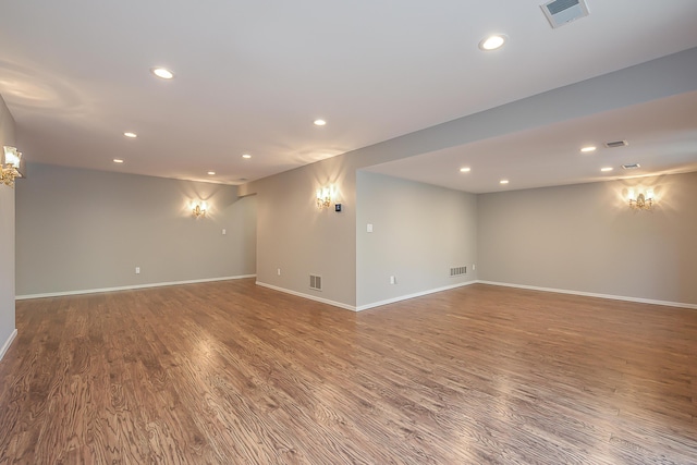 basement with visible vents, recessed lighting, baseboards, and wood finished floors