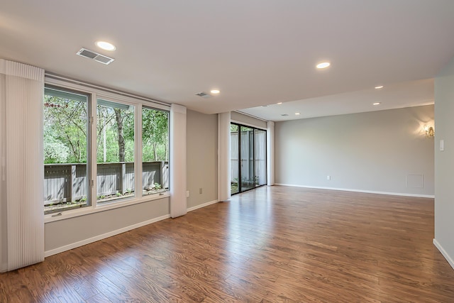 unfurnished room with recessed lighting, baseboards, visible vents, and wood finished floors