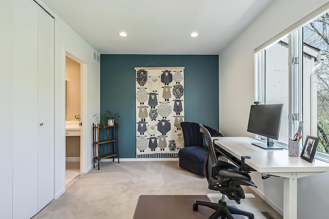 home office with light colored carpet, recessed lighting, a healthy amount of sunlight, and visible vents