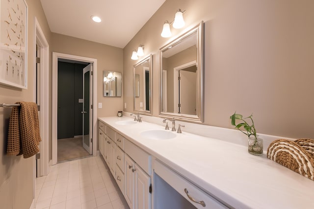 bathroom with double vanity, tile patterned floors, recessed lighting, and a sink