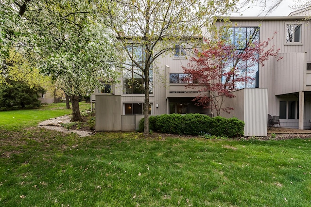 back of house with a lawn