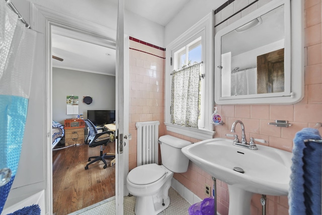 206 S Webster St, Jackson, MI 49203 - ensuite bathroom with tile walls, a sink, toilet, radiator, and ornamental molding