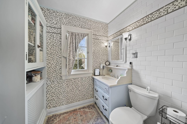 206 S Webster St, Jackson, MI 49203 - bathroom with vanity, baseboards, and toilet