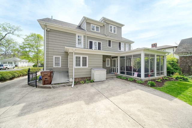206 S Webster St, Jackson, MI 49203 - back of house with a sunroom and a patio area