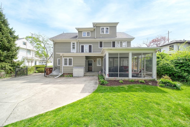 206 S Webster St, Jackson, MI 49203 - rear view of property featuring a yard, a shingled roof, and a sunroom