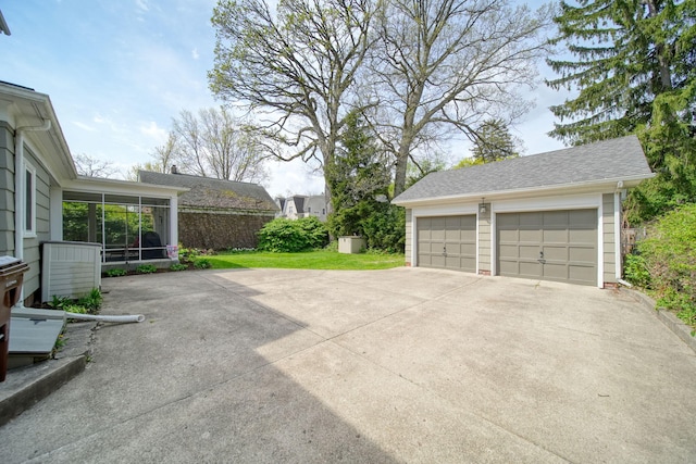 206 S Webster St, Jackson, MI 49203 - view of patio with a sunroom, an outdoor structure, and a detached garage