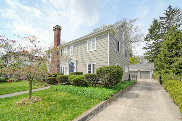 206 S Webster St, Jackson, MI 49203 - colonial house with a detached garage, an outbuilding, a chimney, and a front yard