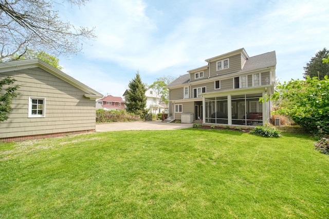 206 S Webster St, Jackson, MI 49203 - back of property featuring a patio, a yard, and a sunroom