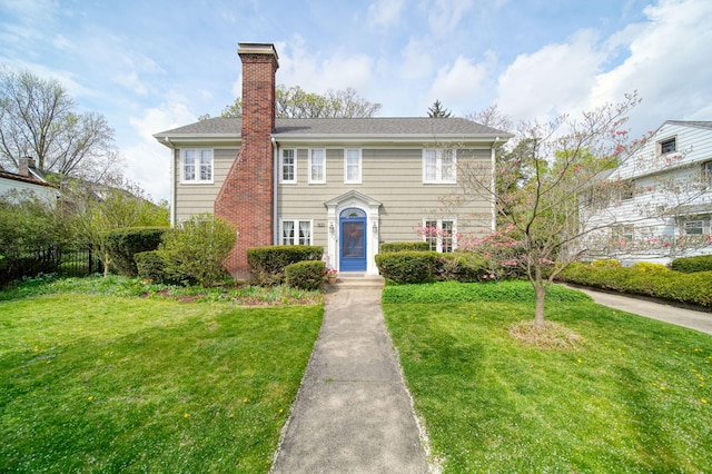 206 S Webster St, Jackson, MI 49203 - view of front of home featuring a chimney, fence, and a front yard
