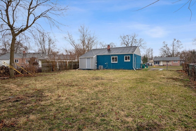 view of yard featuring central AC and fence