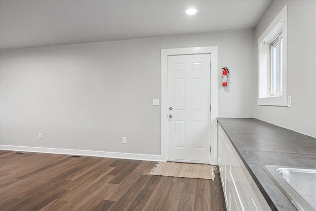 interior space with recessed lighting, baseboards, and dark wood finished floors
