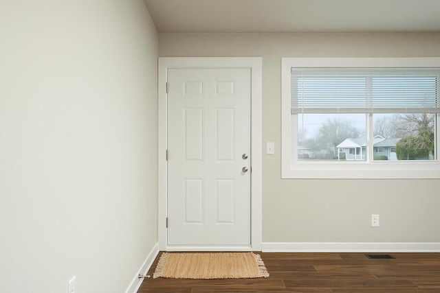 doorway featuring baseboards, visible vents, and dark wood-style floors