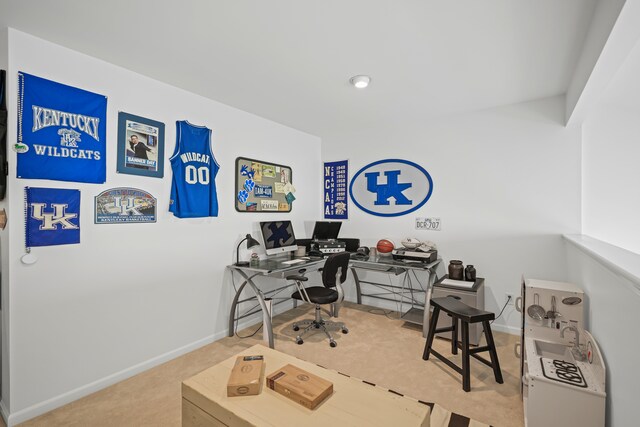 carpeted home office featuring baseboards