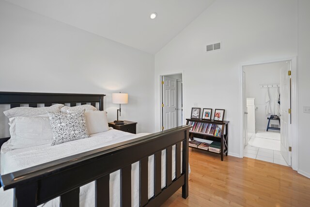 bedroom with light wood-style floors, high vaulted ceiling, recessed lighting, baseboards, and visible vents
