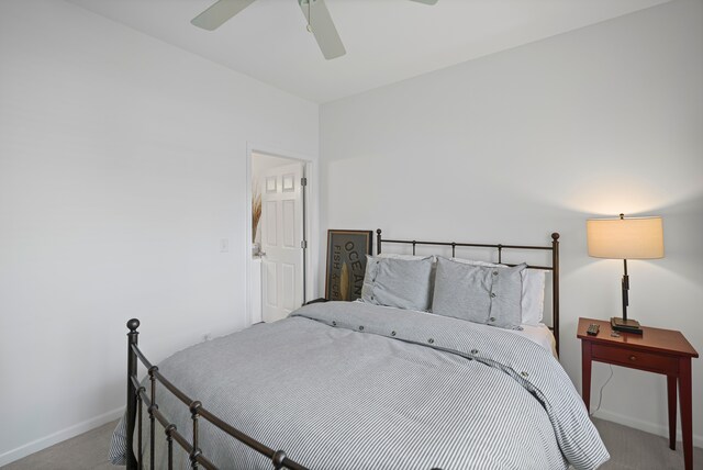 carpeted bedroom featuring baseboards and a ceiling fan