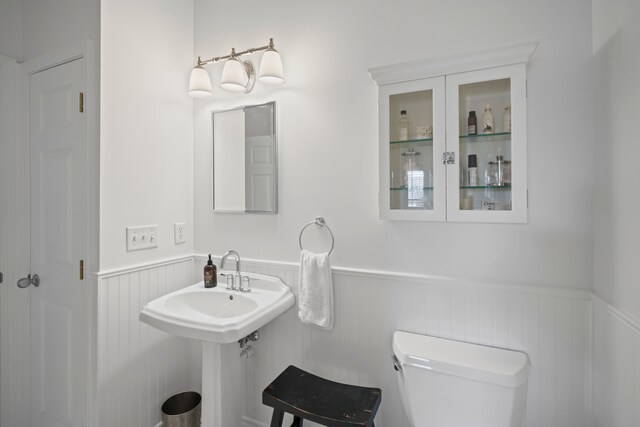 bathroom with wainscoting and toilet