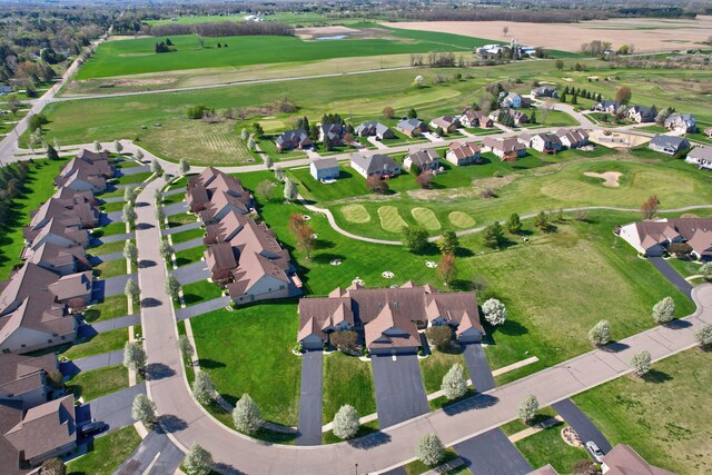 drone / aerial view with a residential view and golf course view