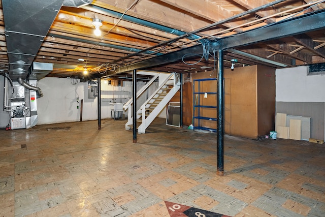 19157 Macarthur, Redford, MI 48240 - unfinished below grade area featuring heating unit, stairs, electric panel, and a sink