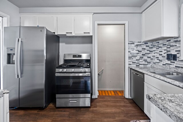 19157 Macarthur, Redford, MI 48240 - kitchen featuring appliances with stainless steel finishes, dark wood-style floors, white cabinetry, decorative backsplash, and a sink