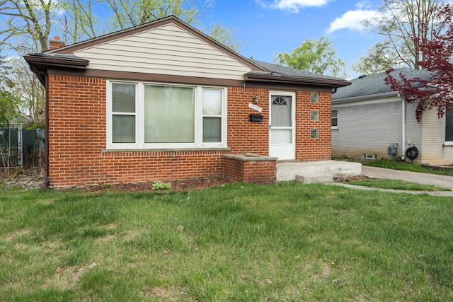 19157 Macarthur, Redford, MI 48240 - bungalow-style house with brick siding, a chimney, and a front lawn