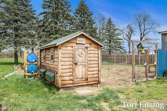 view of shed featuring fence