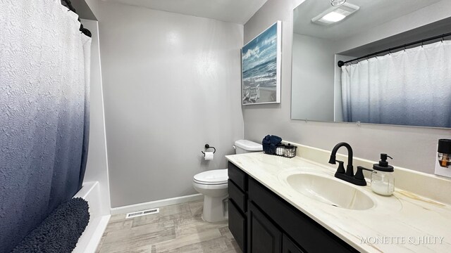 bathroom featuring visible vents, vanity, curtained shower, toilet, and baseboards