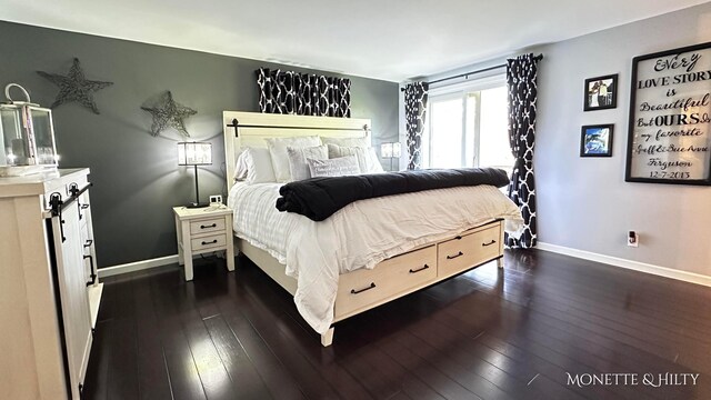 bedroom with dark wood-style flooring and baseboards