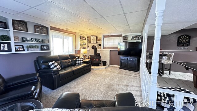 living area with a wood stove and carpet flooring