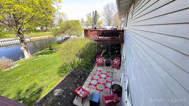view of yard with a deck with water view
