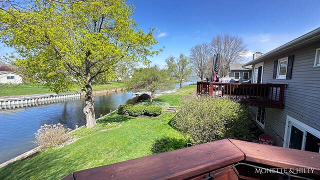 view of yard with a deck with water view