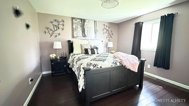 bedroom featuring baseboards and dark wood-style floors
