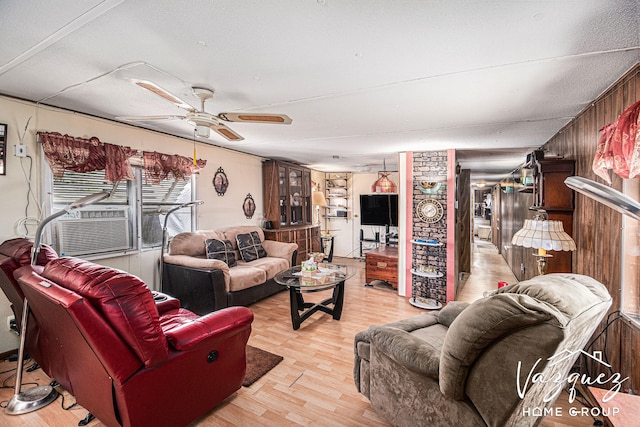 12480 Fargo St NE, Gowen, MI 49326 - living room featuring ceiling fan, cooling unit, wood walls, and light wood-style flooring
