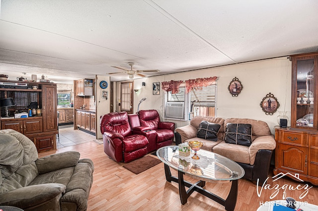 12480 Fargo St NE, Gowen, MI 49326 - living room with a ceiling fan, a textured ceiling, light wood-style flooring, and cooling unit