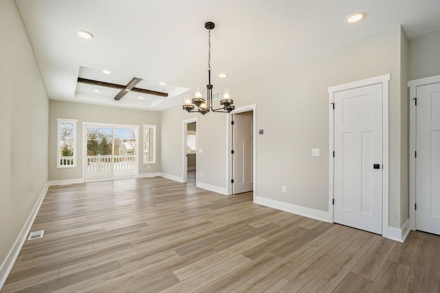 unfurnished dining area featuring an inviting chandelier, light wood-style floors, recessed lighting, visible vents, and coffered ceiling
