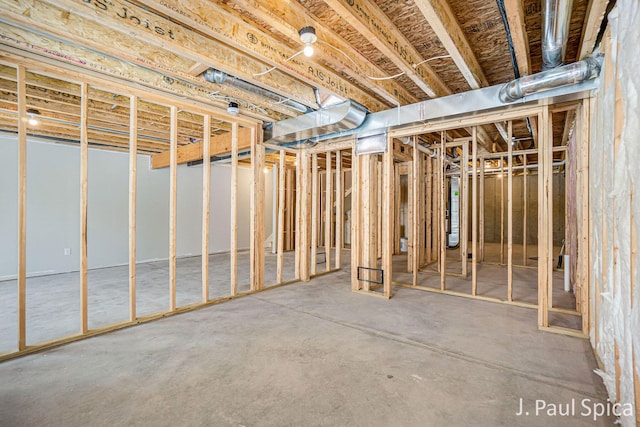 unfinished below grade area featuring water heater