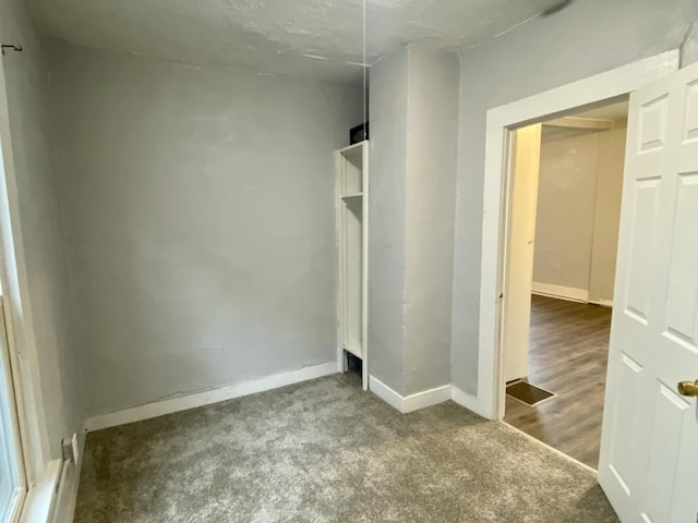 unfurnished bedroom featuring carpet flooring and baseboards