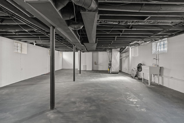 basement with a sink and heating unit