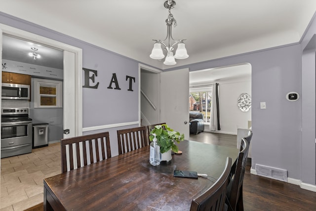 1111 N Franklin St, Dearborn, MI 48128 - dining room with a notable chandelier, visible vents, and baseboards